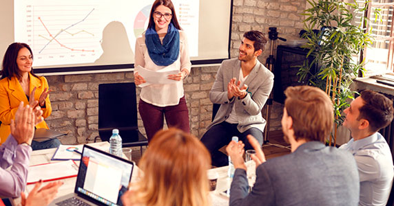 woman giving presentation at a work meeting